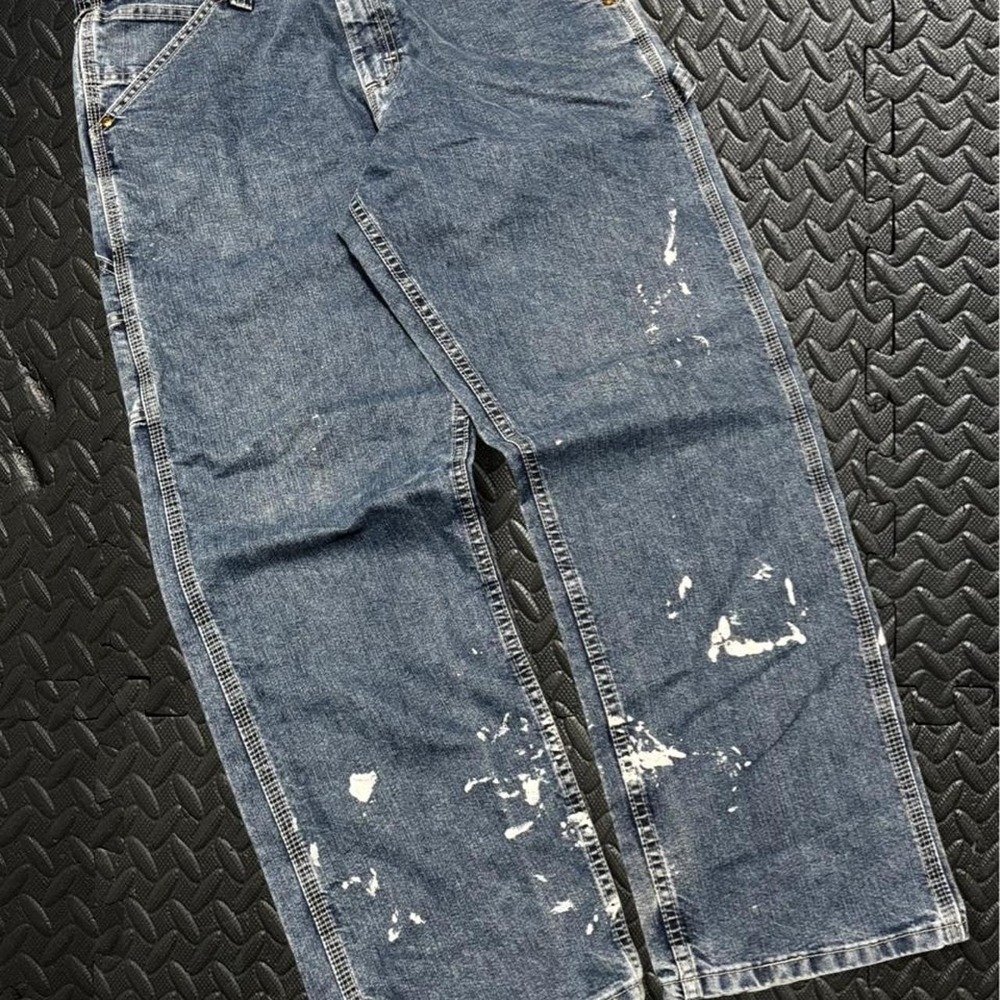 Sick distressed Lee blue denim jeans with paint splatter